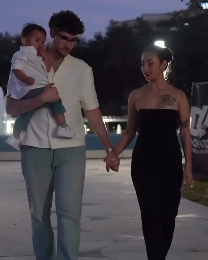 A couple walking hand in hand along the Jacksonville waterfront at night